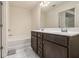 Bathroom featuring a double vanity, tile floors, an enclosed bathtub, a large mirror, and a walk-in shower at 5009 Longview Walk, Decatur, GA 30035