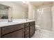Bathroom with double sinks, tile floors, an enclosed toilet, a glass shower, and a large mirror at 5009 Longview Walk, Decatur, GA 30035