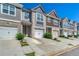A row of charming townhomes each featuring attached garages and driveways with well-maintained landscaping at 5009 Longview Walk, Decatur, GA 30035