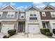 Charming townhome with brick and siding, featuring a one-car garage and a red front door at 5009 Longview Walk, Decatur, GA 30035