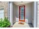 Inviting front door with glass panel, painted a bright red, and sidelights plus house number at 5009 Longview Walk, Decatur, GA 30035