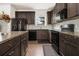 Well-equipped kitchen with dark cabinets, granite countertops, and stainless steel appliances at 5009 Longview Walk, Decatur, GA 30035