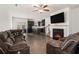 Open-concept living room with a fireplace, dark floors, and plush seating at 5009 Longview Walk, Decatur, GA 30035