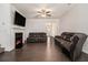 Spacious living room featuring a fireplace, ceiling fan, and dark hardwood floors at 5009 Longview Walk, Decatur, GA 30035