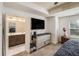 Main bedroom with TV, large windows and open access to ensuite bathroom with double vanity and tile floors at 5009 Longview Walk, Decatur, GA 30035