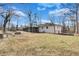 Spacious backyard showcasing a well-maintained lawn and the home's exterior with a screened-in patio at 5774 Forest Dr, Acworth, GA 30102