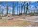 Sprawling backyard featuring stone fireplace and firepit area at 5774 Forest Dr, Acworth, GA 30102