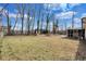 Large backyard featuring a screened-in patio, mature trees, and an outdoor fireplace for entertaining at 5774 Forest Dr, Acworth, GA 30102