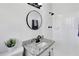 Bathroom features a black framed mirror, granite countertop and a shower with white tiled walls at 5774 Forest Dr, Acworth, GA 30102