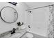 Bathroom features granite countertop and shower/tub combo with white tiled walls at 5774 Forest Dr, Acworth, GA 30102