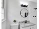 Bathroom features a black framed mirror, granite countertop and a shower with white tiled walls at 5774 Forest Dr, Acworth, GA 30102