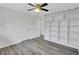 Bedroom with light gray hardwood floors and custom shelving perfect for storage at 5774 Forest Dr, Acworth, GA 30102