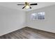 Bright bedroom with light gray hardwood floors and two windows overlooking the yard at 5774 Forest Dr, Acworth, GA 30102