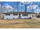 White single-story home with a covered carport and well-maintained lawn during winter at 5774 Forest Dr, Acworth, GA 30102