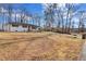 Expansive view of a charming house with a vast front yard, mature trees, and a long driveway at 5774 Forest Dr, Acworth, GA 30102