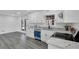 Bright kitchen features white cabinets, stainless steel appliances, granite countertops, and modern flooring at 5774 Forest Dr, Acworth, GA 30102