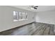 Bright living room showcasing modern gray floors, a ceiling fan, fresh paint, and plenty of natural light at 5774 Forest Dr, Acworth, GA 30102