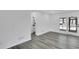 Bright living room featuring light gray hardwood floors and access to a full bath at 5774 Forest Dr, Acworth, GA 30102