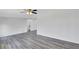 Bright living room with light gray hardwood floors and a ceiling fan at 5774 Forest Dr, Acworth, GA 30102