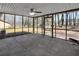 Spacious screened in porch with stone flooring and a ceiling fan at 5774 Forest Dr, Acworth, GA 30102