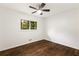 Bedroom featuring wood floors, ceiling fan, and a bright window view at 1019 Crestwood Ln, Stone Mountain, GA 30087