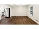Dining area with stainless steel refrigerator, wood floors, and ample natural light at 1019 Crestwood Ln, Stone Mountain, GA 30087