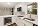 Modern kitchen with white cabinets, stainless steel appliances, including built-in oven, and peninsula at 1019 Crestwood Ln, Stone Mountain, GA 30087