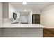 Modern kitchen features white cabinetry, stainless steel appliances, subway tile backsplash, and wood floors at 1019 Crestwood Ln, Stone Mountain, GA 30087