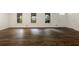 Spacious living area featuring sleek, wood-look flooring and large windows providing ample natural light at 1019 Crestwood Ln, Stone Mountain, GA 30087