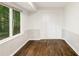 Cozy living room featuring hardwood floors, large window, and white trim at 1019 Crestwood Ln, Stone Mountain, GA 30087