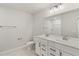 Bathroom featuring double vanity, large mirror, and white cabinets at 1651 Tide Mill Rd, Cumming, GA 30040