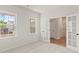 Bright bedroom with neutral walls, carpet, french doors, and two windows providing natural light at 1651 Tide Mill Rd, Cumming, GA 30040