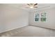 Spacious primary bedroom with tray ceilings, large windows and plush neutral carpeting at 1651 Tide Mill Rd, Cumming, GA 30040