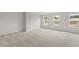 Large bonus room featuring carpet flooring and windows at 1651 Tide Mill Rd, Cumming, GA 30040