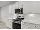 Modern kitchen boasts stainless steel appliances, white cabinets, countertops, and stylish subway tile backsplash at 1651 Tide Mill Rd, Cumming, GA 30040