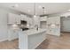 Modern kitchen with white cabinets, stainless steel appliances, a center island, and hardwood floors at 1651 Tide Mill Rd, Cumming, GA 30040