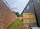 Townhome backyard with wooden privacy fences, green grass, and a retaining wall at 1714 Gunnin Nw Trce # 237, Atlanta, GA 30318