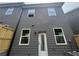Back exterior of a townhouse with gray siding, windows and backyard access at 1714 Gunnin Nw Trce # 237, Atlanta, GA 30318