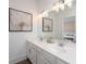 Bathroom with double sink vanity, modern lighting, and a view into the bedroom at 1714 Gunnin Nw Trce # 237, Atlanta, GA 30318