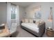 Neutral bedroom showcasing a daybed, decorative wall art, desk, and a window with natural light at 1714 Gunnin Nw Trce # 237, Atlanta, GA 30318