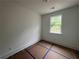 An empty bedroom has a window that offers natural light at 1714 Gunnin Nw Trce # 237, Atlanta, GA 30318