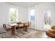 Bright dining room with natural light, modern wood table, stylish chairs, and a neutral-toned rug at 1714 Gunnin Nw Trce # 237, Atlanta, GA 30318