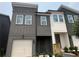 Attractive new construction townhouse with gray siding, white trim, and single-car garage at 1714 Gunnin Nw Trce # 237, Atlanta, GA 30318