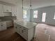 New kitchen features a large island with a white countertop and white cabinets at 1714 Gunnin Nw Trce # 237, Atlanta, GA 30318