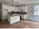 Bright, modern kitchen with white cabinetry, gray backsplash, and a stylish kitchen island at 1714 Gunnin Nw Trce # 237, Atlanta, GA 30318