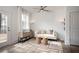 Modern living room with high ceilings, accent wall, ceiling fan, stylish seating, and an outdoor view at 1714 Gunnin Nw Trce # 237, Atlanta, GA 30318