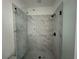 Modern shower with marble tile and sleek black fixtures, creating a luxurious bathing experience at 1714 Gunnin Nw Trce # 237, Atlanta, GA 30318