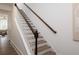 Elegant staircase featuring white railings and stained wood accents, leading to upper level at 1714 Gunnin Nw Trce # 237, Atlanta, GA 30318