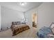 Cozy bedroom with neutral paint, carpet floors and a window with natural light at 221 Irwell Path, Lawrenceville, GA 30044