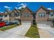 Attractive townhome exterior with brick facade, attached garage, and well-kept front lawn at 221 Irwell Path, Lawrenceville, GA 30044